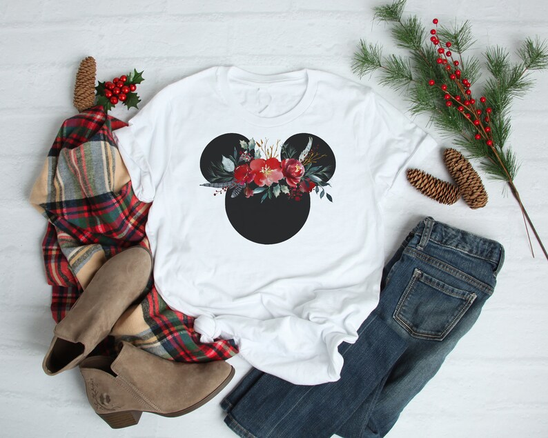 May include: White t-shirt with a black Mickey Mouse silhouette and a red and green floral design on the head.