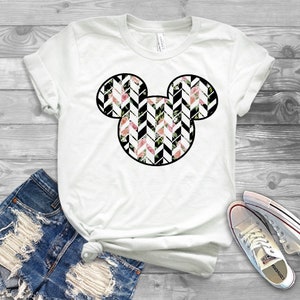 May include: White t-shirt with a black outline of Mickey Mouse's head filled with a black and white chevron pattern with pink and white flowers.