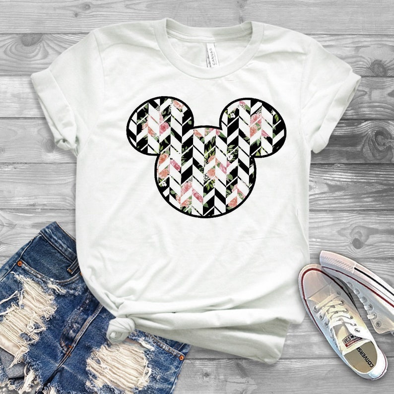 May include: White t-shirt with a black outline of Mickey Mouse's head filled with a black and white chevron pattern with pink and white flowers.