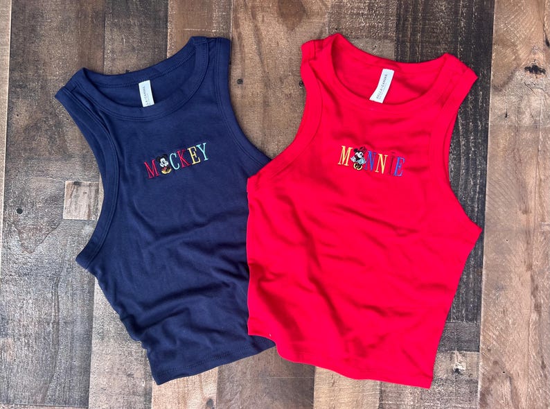 May include: A white ceramic mug with a black handle and the text "But first, coffee" in a handwritten style. The mug is on a white surface. The mug is likely for hot beverages.