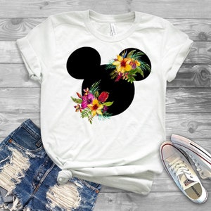May include: White t-shirt with a black Mickey Mouse silhouette and tropical flowers.