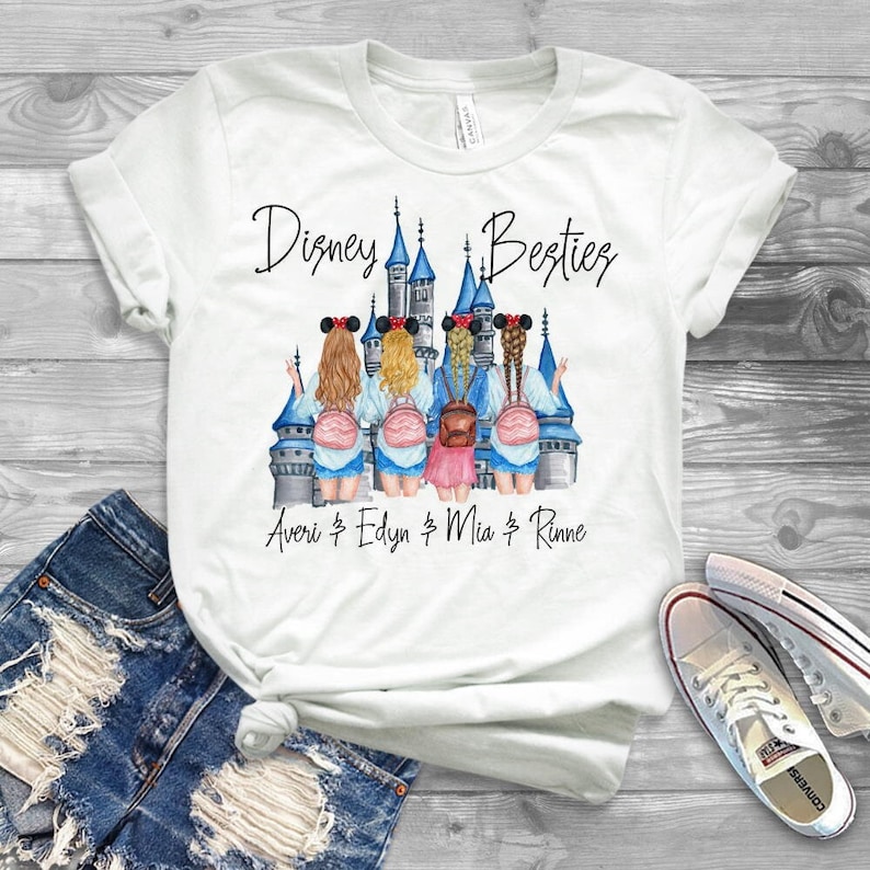May include: White t-shirt featuring a graphic of four girls in front of the Disney castle. The text "Disney Besties" is above the graphic and the text "Averi & Edyn & Mia & Rinne" is below the graphic.