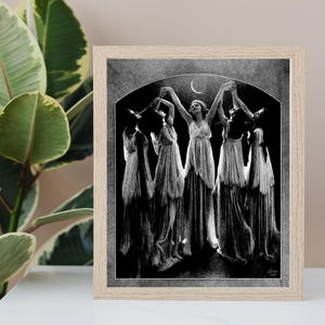 May include: Black and white illustration of a group of women in flowing robes dancing under a crescent moon. The women are holding hands and appear to be in a trance-like state.