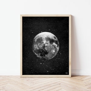 May include: A black and white print of a disco ball moon in a starry night sky.