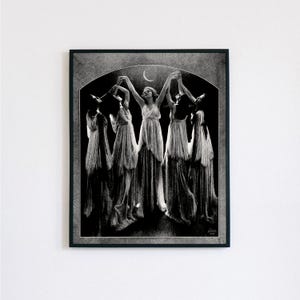 May include: Black and white photograph of five women in long white dresses dancing under a crescent moon. The women are silhouetted against a dark background.