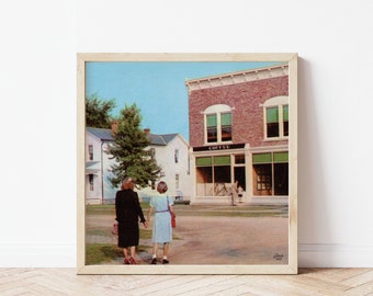 May include: A framed print of a vintage postcard scene. Two people walk hand-in-hand on a path toward a brick building with a "COFFEE" sign. The scene is set in a small town with a blue sky and green trees.