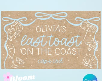 May include: A rectangular sign with the text "Olivia's last toast on the coast Cape Cod" in light blue. The sign features illustrations of a lobster, champagne glass, lemon slice, umbrella, starfish, and seashell. The background is light brown.