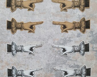 May include: Eight vintage-style paper stickers featuring a hand pointing to the right. The stickers are in two color schemes: black and white, and brown and white.
