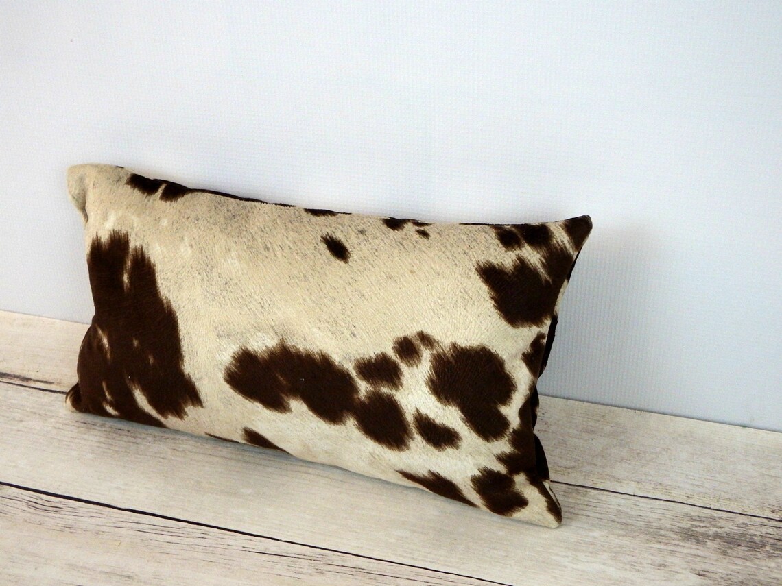 Faux cowhide ottoman cow hide print upholstered ottoman Etsy