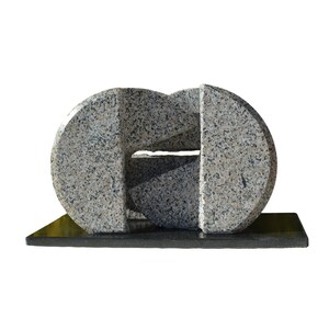 Puede incluir: Escultura abstracta de granito con un patrón moteado gris claro y negro. La escultura presenta dos formas redondeadas conectadas por una abertura central, montada sobre una base rectangular negra. Una obra de arte moderna.