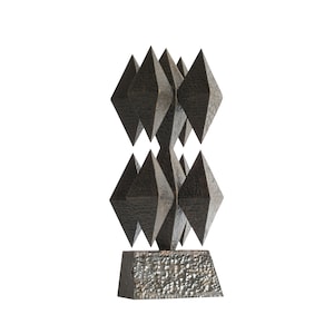 May include: A black metal sculpture with a geometric design. The sculpture is made up of multiple diamond shapes stacked on top of each other. The sculpture is on a black base.