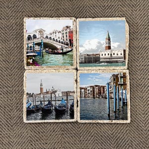 May include: Set of four square coasters featuring images of Venice, Italy. Each coaster has a different view of the city, including a bridge, a canal, and a church.