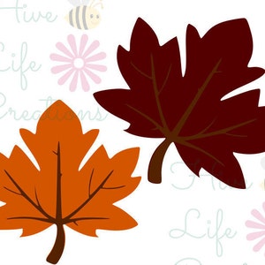 May include: Two autumn leaves, one orange and one brown, are shown against a white background with pink flowers and bees.