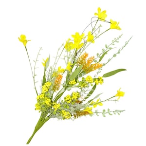 May include: A vibrant bouquet of artificial flowers featuring bright yellow daffodils, small yellow berries, and orange accents. Green leaves and stems provide contrast against the white background. A cheerful floral arrangement.