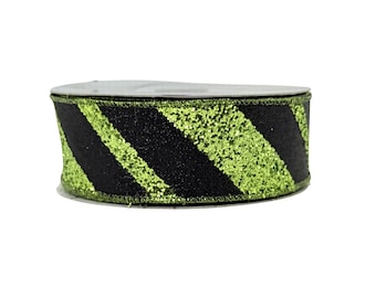 May include: A roll of decorative ribbon with a black and lime green glitter stripe pattern. The ribbon is on a white spool and is suitable for crafts, gift wrapping, or holiday decorations.