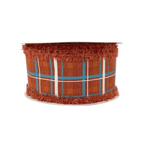 May include: A roll of decorative ribbon with a plaid pattern in shades of brown, teal, and white. The ribbon has a frayed edge and is suitable for crafts and gift wrapping.