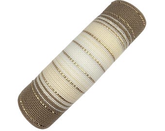 May include: A cylindrical roll of decorative mesh ribbon featuring a striped pattern in shades of beige, cream, and white, accented with thin, shimmering metallic gold threads woven throughout the open-weave, grid-like fabric texture.
