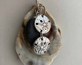 Sea shell pendant necklace, ocean shells clustered with a chunky price of green sea glass and sand dollar charms