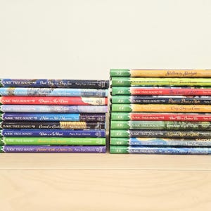 May include: Two stacks of "Magic Tree House" children's books. The books have colorful covers with titles like "Dark Day in the Deep Sea" and "Stalling by Starlight." The spines are green with the series logo.
