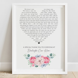 May include: A white framed print with a black and white text message thanking everyone at Darlington Care Home. The text is surrounded by a floral design with pink, blue, and green flowers.