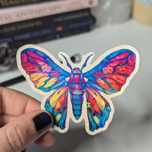 Leuchtend bunte Motten Sticker mit holografischem Stern Schein Mystisch