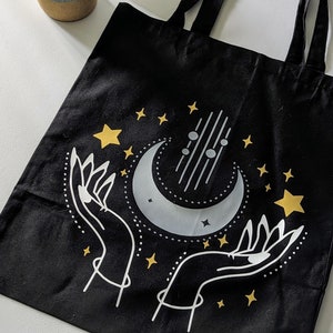 Black Tote Bag with Hands and Moon with Gold Star Highlights
