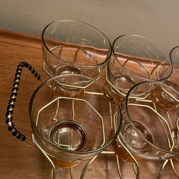 Vintage set of 8 clear and gold rocks glasses in gold metal caddy with black detail