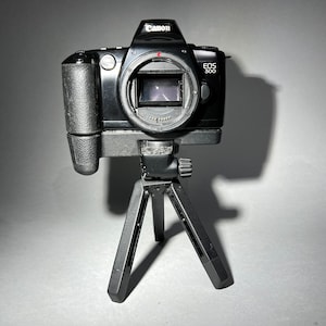 Canon EOS 500 SLR film camera body with gr-80TP tripod grip and FREE roll of 35mm film