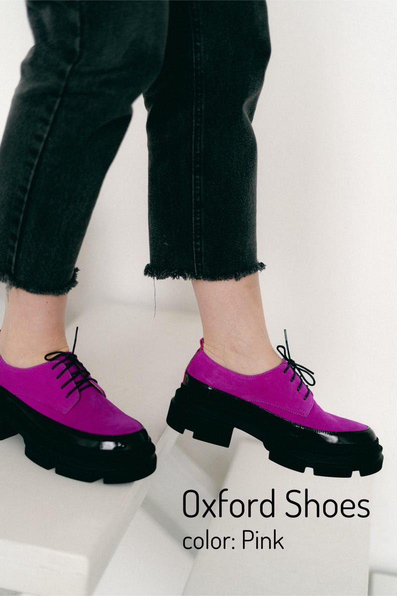 Pink suede Oxford shoes with black patent leather trim and chunky black soles