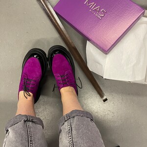 May include: Purple suede lace-up shoes with black soles and a box that says "MIAS Made in Italy".