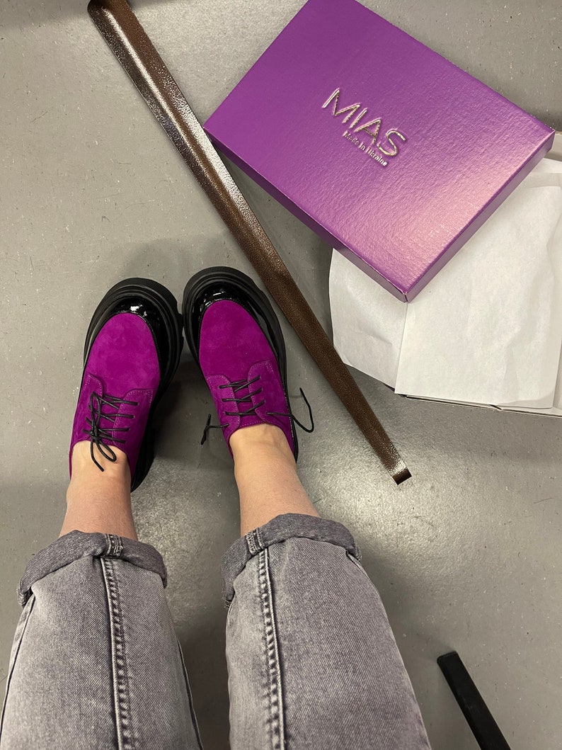 May include: Purple suede lace-up shoes with black soles and a box that says "MIAS Made in Italy".