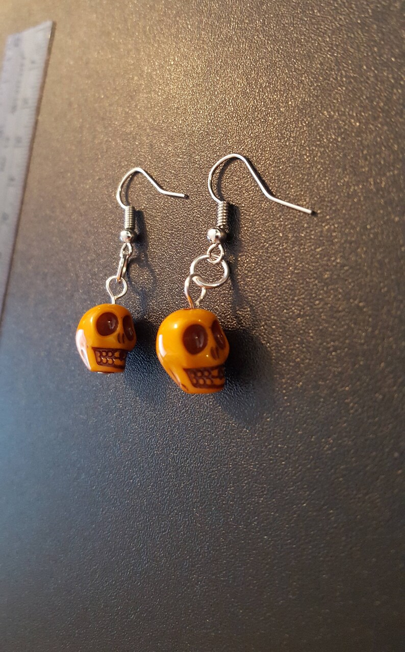 Yellow acrylic skull beaded drop dangle earrings with silver detail image 1