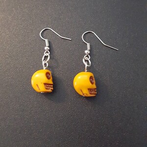 Yellow acrylic skull beaded drop dangle earrings with silver detail image 3