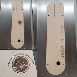 May include: A beige wooden template for a table saw insert with the text "AxeDangler" and a logo for "Juice's Woodworking and Design" with a stylized leaf design.