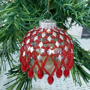 Handmade beaded ornament red and silver over a clear ball about 3 in diameter