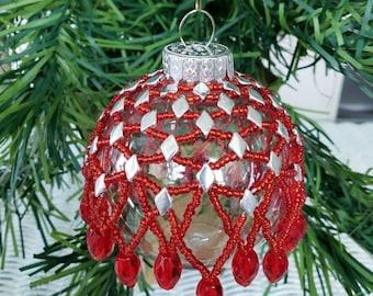 Handmade beaded ornament red and silver over a clear ball about 3 in diameter