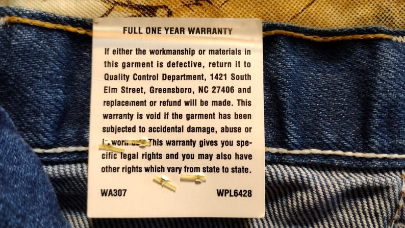 Puede incluir: Una etiqueta blanca con texto negro unida a una tela vaquera azul. La etiqueta dice "Full One Year Warranty" e incluye detalles sobre la garant&iacute;a y la informaci&oacute;n de contacto del Departamento de Control de Calidad. La etiqueta tambi&eacute;n incluye los n&uacute;meros WA307 y WPL6428.