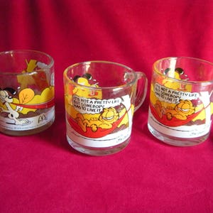 Three Different  McDonald&#39;s GARFIELD the Cat &quot;It&#39;s Not A Pretty Life But Somebody...&quot; Collectible Vintage Glass Mugs 1978