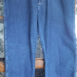 Puede incluir: Un par de pantalones vaqueros azules de mezclilla con cierre de bot&oacute;n y trabillas para cintur&oacute;n.