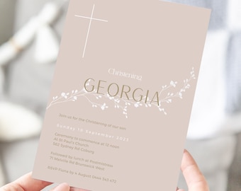May include: A light brown card with a white cross at the top and a floral design with the name "GEORGIA" in gold lettering. The text reads "Christening of our son, Sunday 10 September 2023, Ceremony to commence at 12 noon, At St Paul's Church, 562 Sydney Rd Coburg, Followed by lunch at Postmistress, 71 Melville Rd Brunswick West, RSVP Fiona by 4 August 0444 343 472."