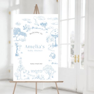 May include: A blue and white baby shower welcome sign with a Winnie the Pooh theme. The sign features a quote: "Sometimes the smallest things take up the most room in your heart."