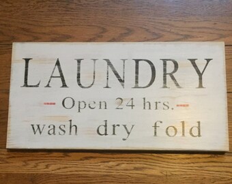 LAUNDRY OPEN 24 HOURS sign