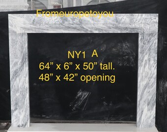 May include: A white marble fireplace mantel with a black background. The mantel is 64 inches wide, 6 inches deep, and 50 inches tall. The opening is 48 inches wide and 42 inches tall. The text "NY1 A" is written on the mantel.