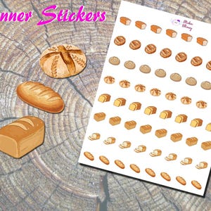 May include: Planner stickers featuring various bread illustrations. The stickers include images of loaves, rolls, and sliced bread in shades of brown and tan. The stickers are on a white sheet and scattered on a wooden surface.