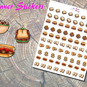 May include: Planner stickers featuring various food illustrations, including a sandwich, a meatball sub, and a pita wrap. A sheet of stickers with miniature sandwiches, burgers, and other food items is also present.
