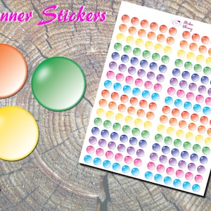 May include: A sheet of rainbow coloured planner stickers with a variety of sizes and shapes. The stickers are glossy and have a 3D effect. The sheet is labelled "Planner Stickers".