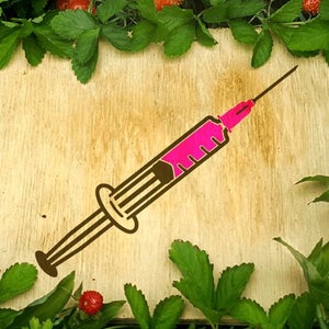 May include: A wooden background with green leaves and red strawberries surrounding a pink and brown syringe with the text "Smoke and Strawberries".