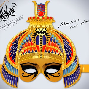 May include: Gold paper mask with a detailed design of an Egyptian pharaoh's headdress, including a cobra, feathers, and geometric patterns. The mask has a black eye mask with a gold design. The text "More in our store" is written in cursive on the right side of the image.