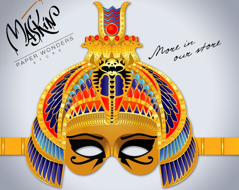 May include: Gold paper mask with a detailed design of a pharaoh's headdress, including a cobra, feathers, and geometric patterns. The mask has a black eye mask with a gold design. The text "Maskin Paper Wonders Store" is visible in the top left corner. The text "More in our store" is visible in the top right corner.