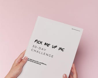 May include: A white booklet with the title "PICK ME UP INC 30-DAY CHALLENGE" is held by two hands against a pink backdrop. The text "A daily boost for confidence, clarity & consistency" is also visible. The booklet's corner has the text "@pickmeupincuk".